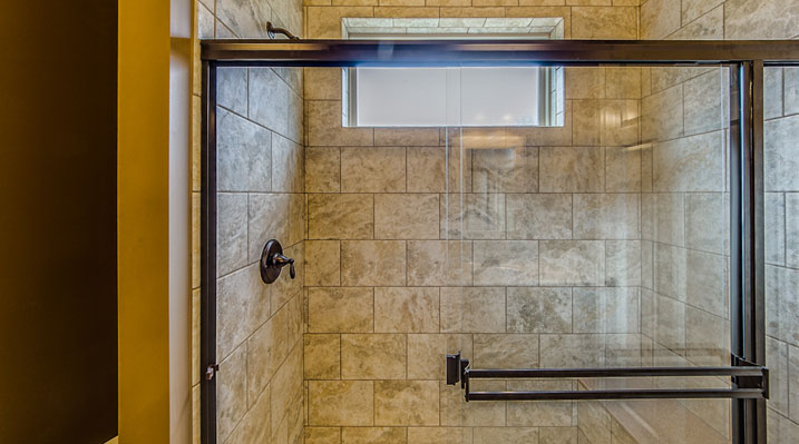 ICH Builders Linworth Worthington residence custom build showing standing shower with glass door and beautiful tiling