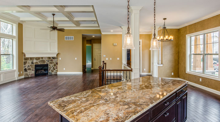 ICH Builders Linworth Worthington residence custom build showing main floor with fireplace from open kitchen area