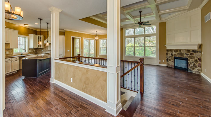ICH Builders Linworth Worthington residence custom build main floor with stairs in center of living area leading down to basement
