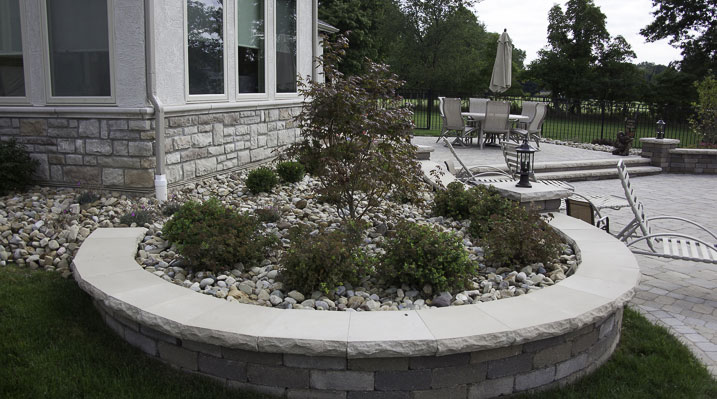 ICH Builders New Albany Ohio residence custom build showing custom-built block retaining wall with a smooth stone cap