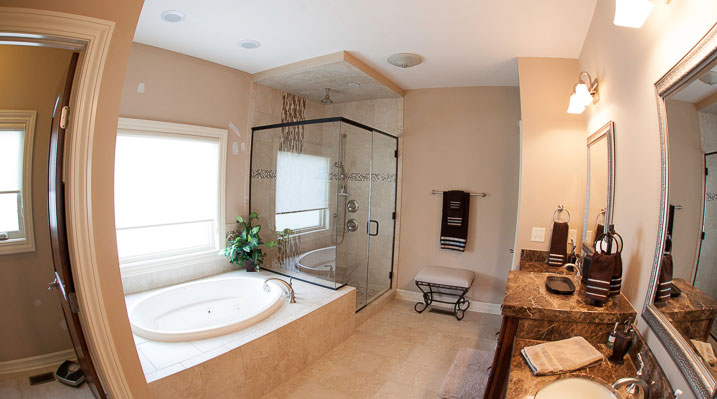 ICH Builders New Albany Ohio residence custom build bathroom with oval bathtub, glass enclosed shower and marble countertops