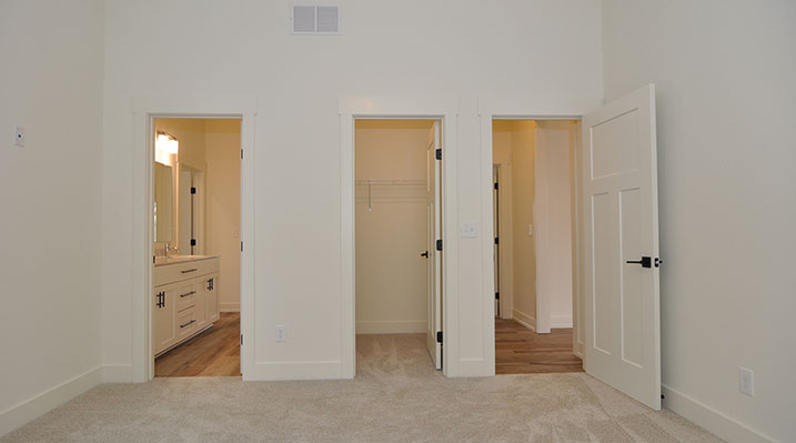 ICH Builders Dublin Ohio residence custom build bedroom showing attached bathroom and closet space