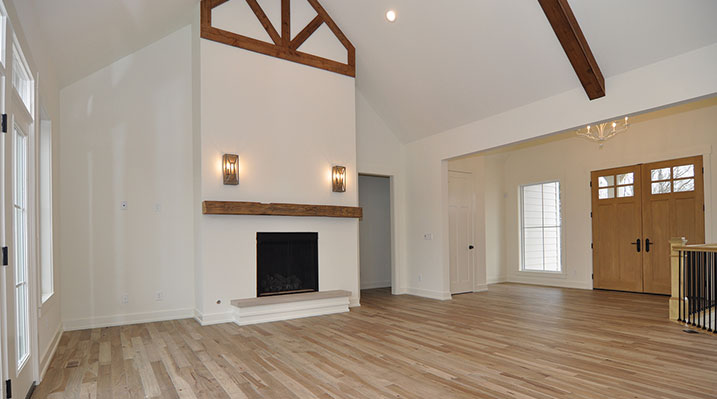 ICH Builders Dublin Ohio residence custom build main floor looking towars front double doors and fireplace