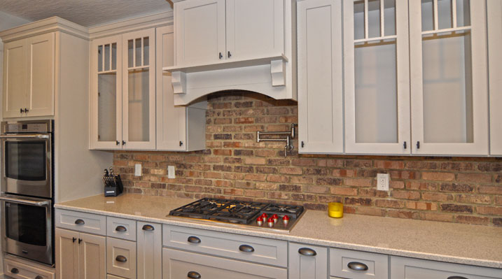 ICH Builders Berlin Ohio residence custom build kitchen showing close up of the white cabinets and the brick inspired backsplash
