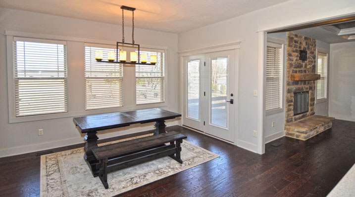ICH Builders Berlin Ohio residence custom build dining area with picnic style eating table and fireplace nearby