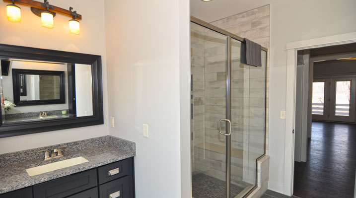 ICH Builders Berlin Ohio residence custom build view of bathroom dark wood vanity and shower with glass door