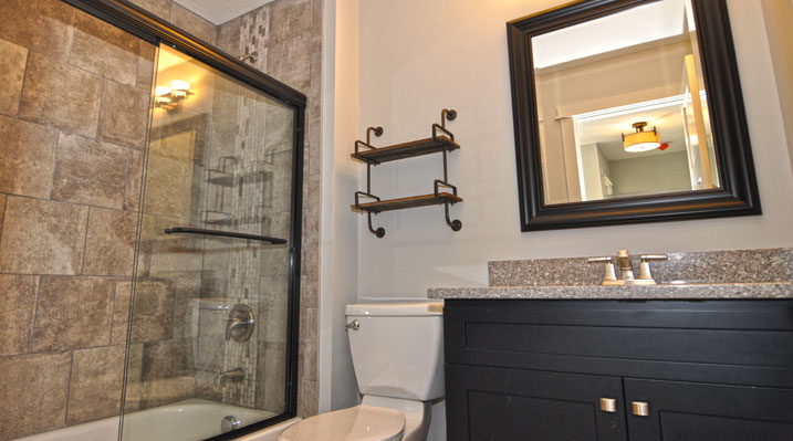 ICH Builders Berlin Ohio residence custom build another view of the bathroom darkwood vanity and bathtub with large tile wall paneling