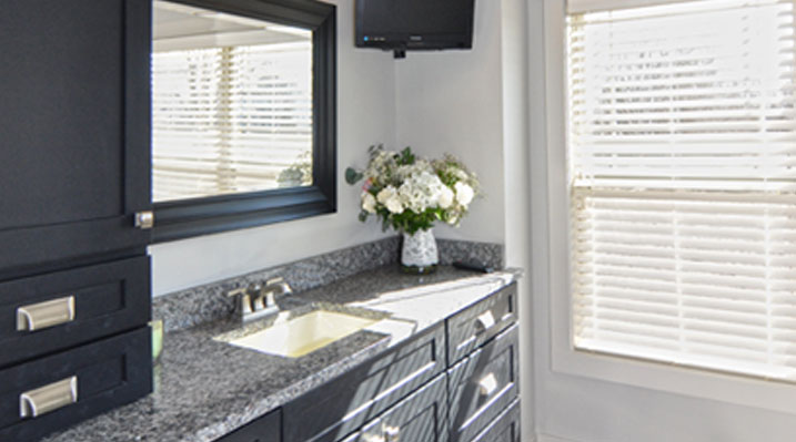 slider image of Berlin Ohio residence custom build another view of the bathroom showcasing the marble countertops and marble countertop vanity