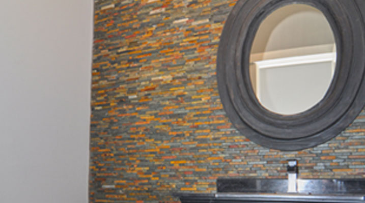 slider image of Berlin Ohio residence custom build half bathroom with circular mirror