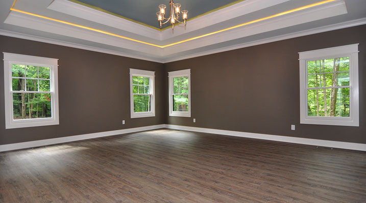 Iulianelli Custom Homes Lithopolis Ohio residence custom build master bedroom showing wood floors, dark brown walls with white trim and crown molding