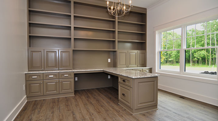 ICH Lithopolis Ohio residence custom build office with gold chandelier, light brown cabinets and book case, and marble countertops