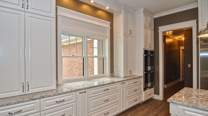 ICH Lithopolis Ohio residence custom build kitchen area with white drawers and cabinets and granite countertops