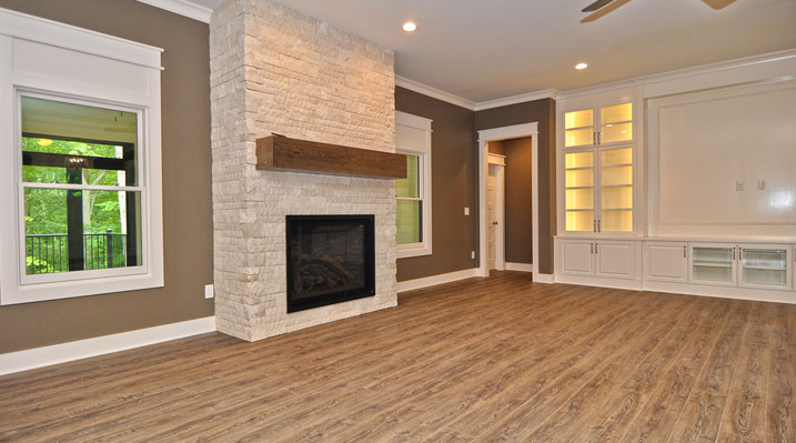 ICH Lithopolis Ohio residence custom build the main living area featuring a full-height stacked stone fireplace