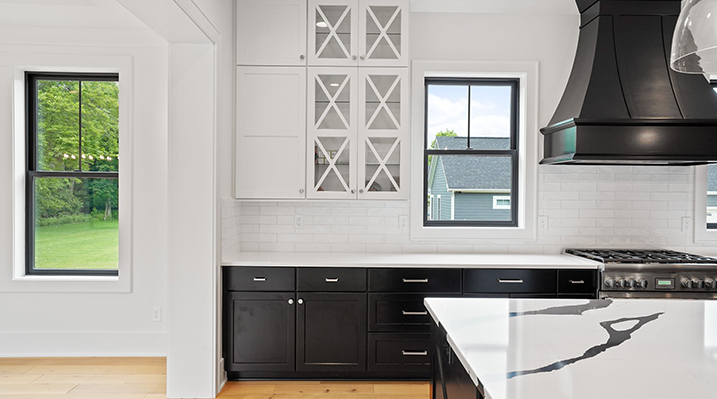 ICH Builders Canal Winchester Ohio residence custom build kitchen with white cabinets and black drawers