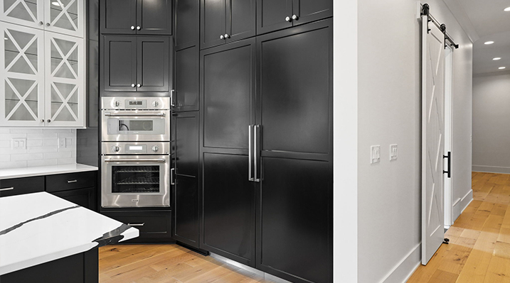 ICH Builders Canal Winchester Ohio residence custom build another view of the open kitchen showing large refrigerator black doors and silver ovens