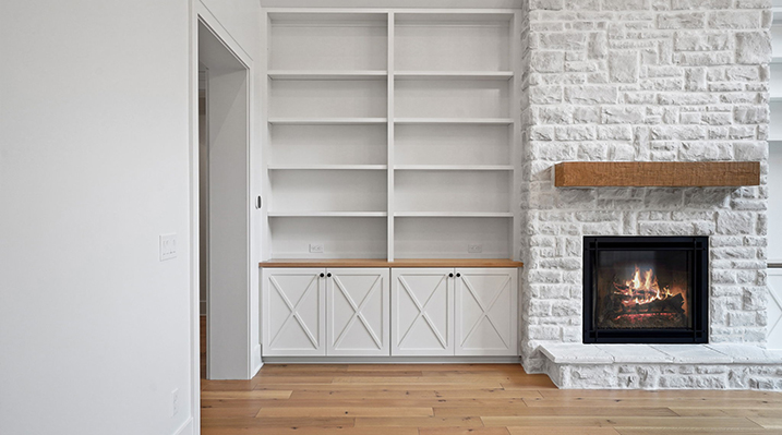 ICH Builders Canal Winchester Ohio residence custom build main room white brick fireplace next to built in white bookshelves