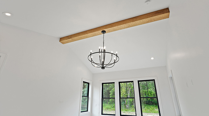 ICH Builders Canal Winchester Ohio residence custom build close up of black 10-Light Chandelier hanging from wooden beam