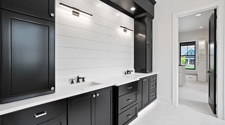 ICH Builders Canal Winchester Ohio residence custom build bathroom with white countertops and black cabinets and drawers with silver fixtures