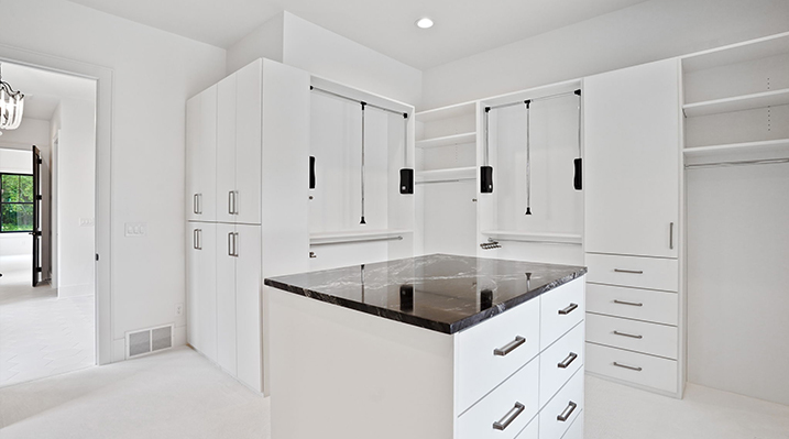 ICH Builders Canal Winchester Ohio residence custom build another view of the wardrobe island with black granite countertop and white drawers