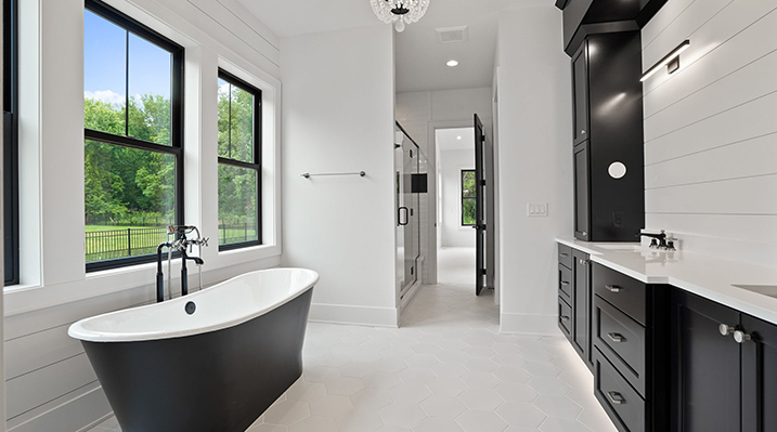 ICH Builders Canal Winchester Ohio residence custom build another view of the black and white styled bathroom with external bathtub looking towards the attached bedroom