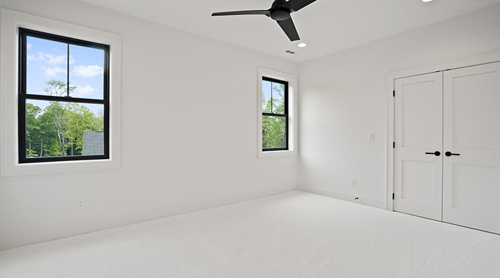 ICH Builders Canal Winchester Ohio residence custom build white bedroom with black 3 blade hanging ceiling fan