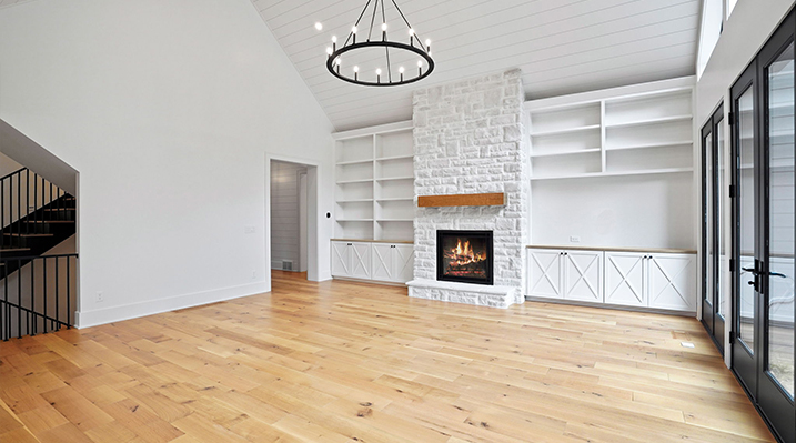 ICH Builders Canal Winchester Ohio residence custom build another view of the main room with white stonefireplace and black wagon wheel chandelier