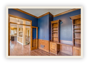 thumbnail image of Iulianelli Custom Homes Linworth custom house room with wooden shelving and wood paneling covering the bottom third of blue painted walls