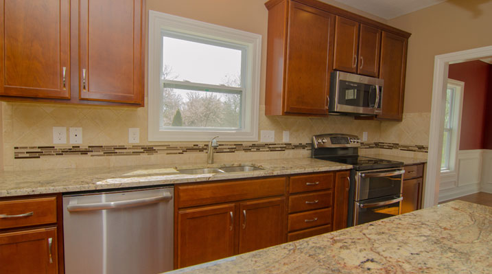 Iulianelli Custom Homes Oakland Model kitchen before cabinets were painted white and new handles added