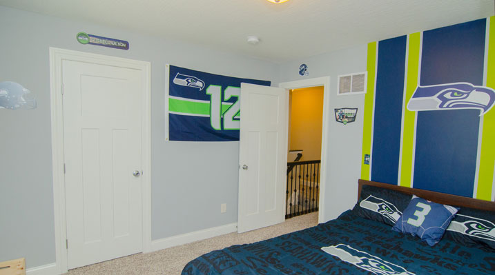 Iulianelli Custom Homes Belmont Model bedroom decorated with Seattle Seahawks gear