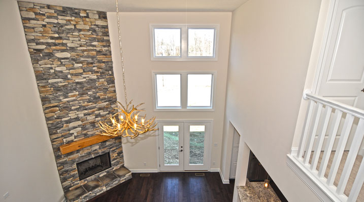Iulianelli Custom Homes Oakland Model looking down towards the rear doors from the second floor mezzanine or galleried landing