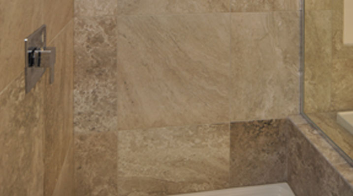 slider image of Oakland Model stand alone shower focusing on custom tile work