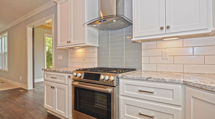 Iulianelli Custom Homes Kingsdale Model kitchen area focusing on counters and backsplash